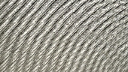 silver woven zigzag textile closeup with metallic sheen ideal for abstract background or modern fabric texture design