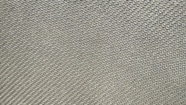 silver woven zigzag textile closeup with metallic sheen ideal for abstract background or modern fabric texture design