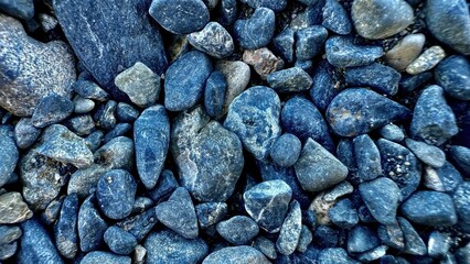 natural riverbed blue gray pebbles closeup with smooth stone texture ideal for background surface design or wall pattern