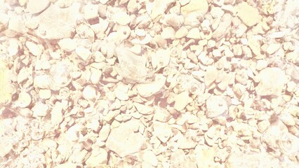 pale riverbed stones under clear shallow water with shimmering bubbles creating natural texture perfect for abstract background or design overlay