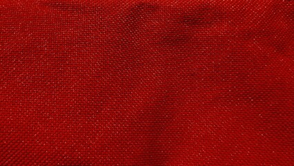 rich red woven textile fabric closeup with detailed texture ideal for fashion background or...