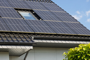 Obraz premium Photovoltaic solar panels on sloped roof