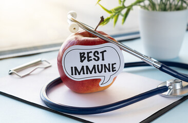 A paper with the word Best Immune written on it is placed on top of an apple.