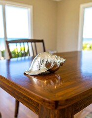 Polished seashell on wooden table (2)