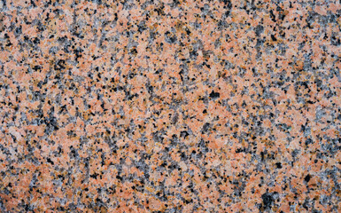 Red granite texture, background of granite stone close up