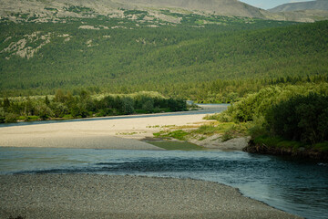 A winding river among forests and green hills