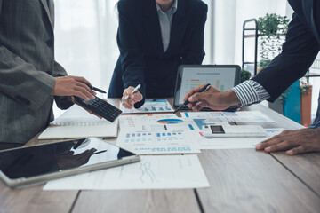 Business team meeting to analyze and discuss the situation in the financial report in the meeting room, investment consultant, financial consultant and accounting consultant.