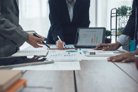 Business team meeting to analyze and discuss the situation in the financial report in the meeting room, investment consultant, financial consultant and accounting consultant. - Powered by Adobe