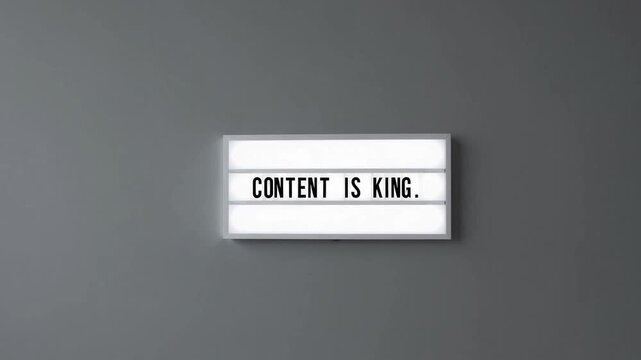 marketing concept with the phrase Content Is King written on white lightbox against gray wall