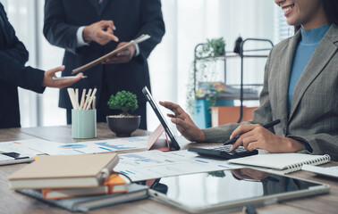 Auditor and accountant team working in office, analyze financial data and accounting record with calculator. Accounting company provide finance and taxation planning for profitable cash flow. Insight