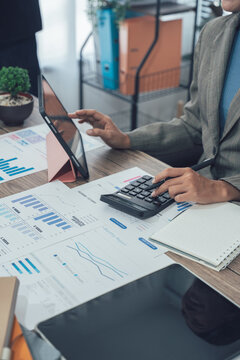 Auditor and accountant team working in office, analyze financial data and accounting record with calculator. Accounting company provide finance and taxation planning for profitable cash flow. Insight