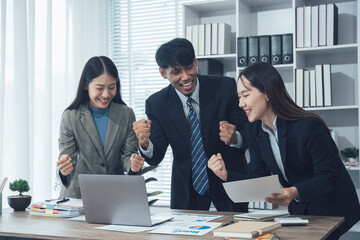 Young Asian businesswoman and businessman discuss investment project working and planning strategy on digital tablet. Business people talking together with tablet at office.