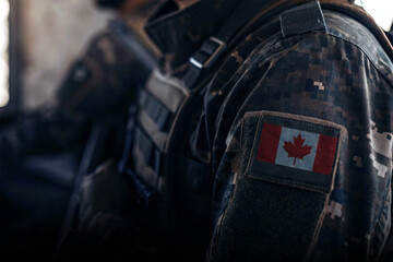 Close-up of a soldier’s uniform with a Canada flag patch, perfect for military themes, patriotism concepts, tactical gear, and defense illustrations.