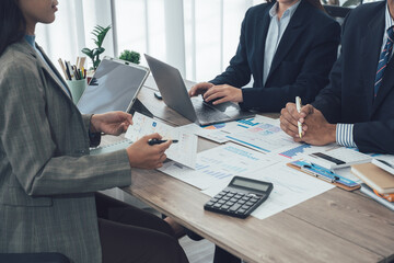 Businesswomen analyzing financial charts and data on desk