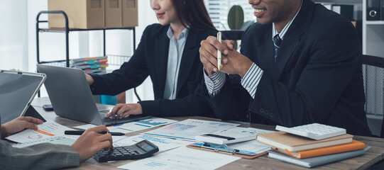 Businesswomen analyzing financial charts and data on desk