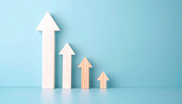 Wooden white arrow rise up on blue background. Investment, business growth. Close-up.