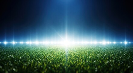 A vibrant, illuminated field of green grass under stadium lights at night.