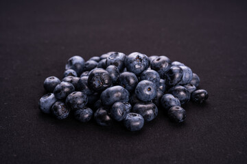 Blueberries on a white plate with isolated black background