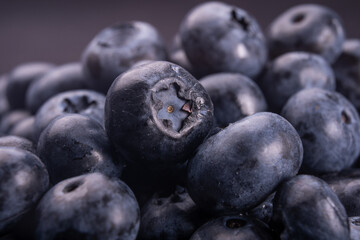 Blueberries on a white plate with isolated black background