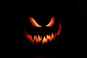 Fototapeta premium Evil Glowing Jack-o’-Lantern in the Dark