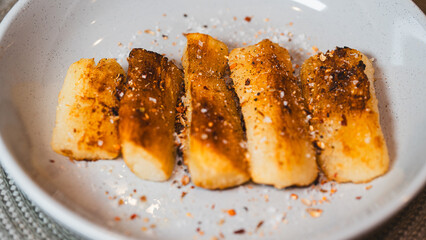 Crispy golden fried cassava sticks seasoned with aromatic spices and chili peppers. A perfect savory snack, ideal for Brazilian cuisine themes, street food, and appetizer menus.