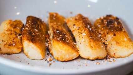 Crispy golden fried cassava sticks seasoned with aromatic spices and chili peppers. A perfect savory snack, ideal for Brazilian cuisine themes, street food, and appetizer menus.