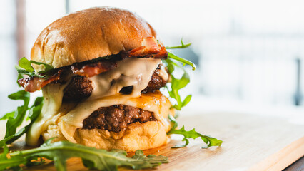 A towering double-deck bacon cheeseburger with juicy, rare beef patties, melted cheese, and crispy bacon. Perfect for gourmet burger spots, food blogs, and indulgent culinary content.