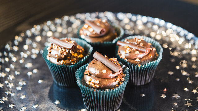 Beautiful assorted chocolate cupcakes with creamy frosting and colorful toppings, styled on a chic plate. Ideal for dessert content, baking inspiration, and joyful food storytelling.