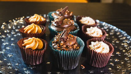 Beautiful assorted chocolate cupcakes with creamy frosting and colorful toppings, styled on a chic plate. Ideal for dessert content, baking inspiration, and joyful food storytelling.