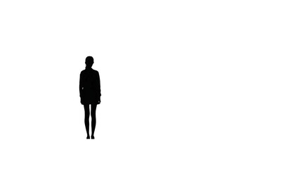 Obraz premium Silhouette of a person standing confidently against a stark black background, perfect for conveying mystery, anticipation, or a sense of solitude, ideal for creative projects
