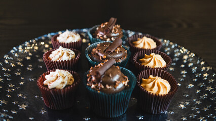 Beautiful assorted chocolate cupcakes with creamy frosting and colorful toppings, styled on a chic plate. Ideal for dessert content, baking inspiration, and joyful food storytelling.