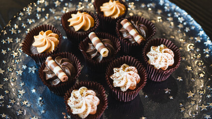 Beautiful assorted chocolate cupcakes with creamy frosting and colorful toppings, styled on a chic plate. Ideal for dessert content, baking inspiration, and joyful food storytelling.