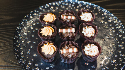 Beautiful assorted chocolate cupcakes with creamy frosting and colorful toppings, styled on a chic plate. Ideal for dessert content, baking inspiration, and joyful food storytelling.