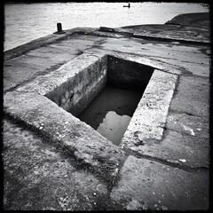 Monochrome Photo of Recessed Water Basin on Concrete Dock
