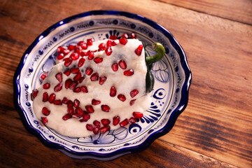 Chiles en Nogada, a typical Mexican dish. Poblano chile stuffed with meat and fruit, topped with a walnut, parsley, and pomegranate sauce. A tradition during Mexican national holidays.