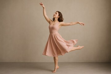 Naklejka premium Young ballerina in a flowing pink dress executes a graceful dance pose, showcasing fluidity and poise against a neutral backdrop