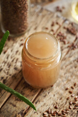 Homemade flax seed gel in a glass jar - ingredient for natural diy shampoo. Alternative haircare, no poo.
