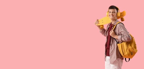 Teenage boy with skateboard, headphones and backpack on pink background with space for text