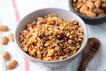 Crunchy homemade granola with almonds and cranberries in a bowl