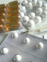 Detailed image showcasing pharmaceutical capsules and tablets in blister packs, featuring diverse shapes and designs, suggesting themes of healthcare, medicine, and prescriptions.