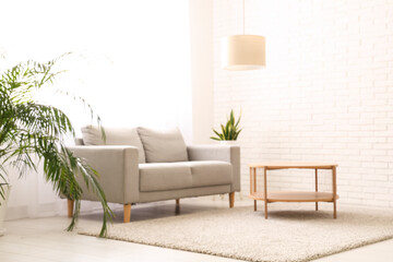 Interior of stylish living room with grey sofa, table and light curtains