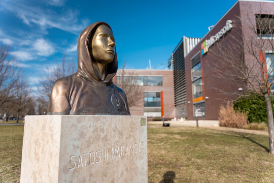 Budapest, Z&aacute;hony u. 7, Hungary - February 10, 2024: Statue of Satoshi Nakamoto. Microsoft office on the background.