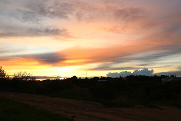 Beautiful bright orange sunset in the mountains with clouds