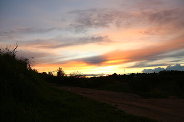 Beautiful bright orange sunset in the mountains with clouds