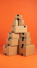 Obraz premium A pyramid of stacked cardboard delivery boxes against a bright orange background, suggesting shipping and logistics