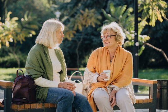 Elderly women enjoying relaxing time together in park