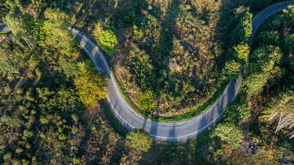 Landstraße aus der Vogelperspektive kurvenreiche Straße durch einen Wald