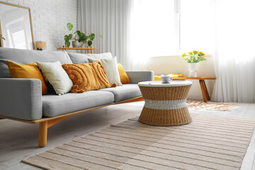 Interior of modern light living room with sofa and table