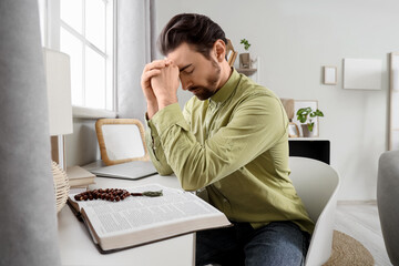 Religious man praying at  home