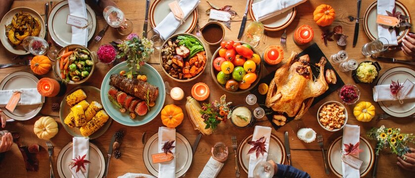 Festive Thanksgiving table with roasted turkey, vegetables, and fruits. Thanksgiving feast with turkey, vibrant vegetables, and seasonal fruits. Autumn holiday dining table with Thanksgiving feast - Powered by Adobe